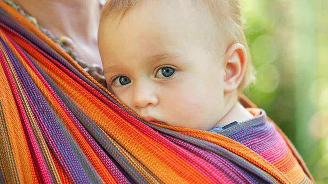 baby in sling carrier